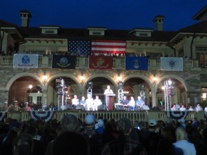 Jim Furyk addresses the crowd in front of a decked out Clubhouse. The big star of the night was the war veteran seated to the right.
