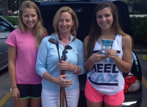 Kerrie Lecker with her daughters taking delivery of her old set of hickories.