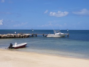 The tranquil beach at Pristine Bay Resort. That boat is the ticket to the Caribbean Sea!