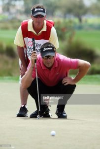 Robert Allenby of Australia and his caddie line up a birdie putt. Photo Credit: Getty Images